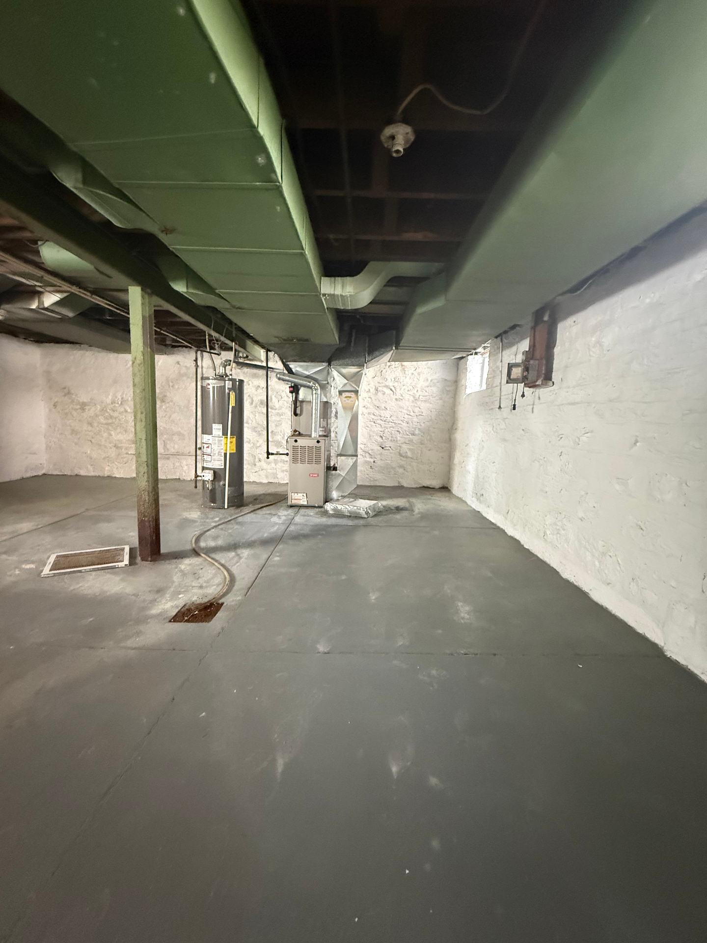 Basement utility area with furnace and water heater