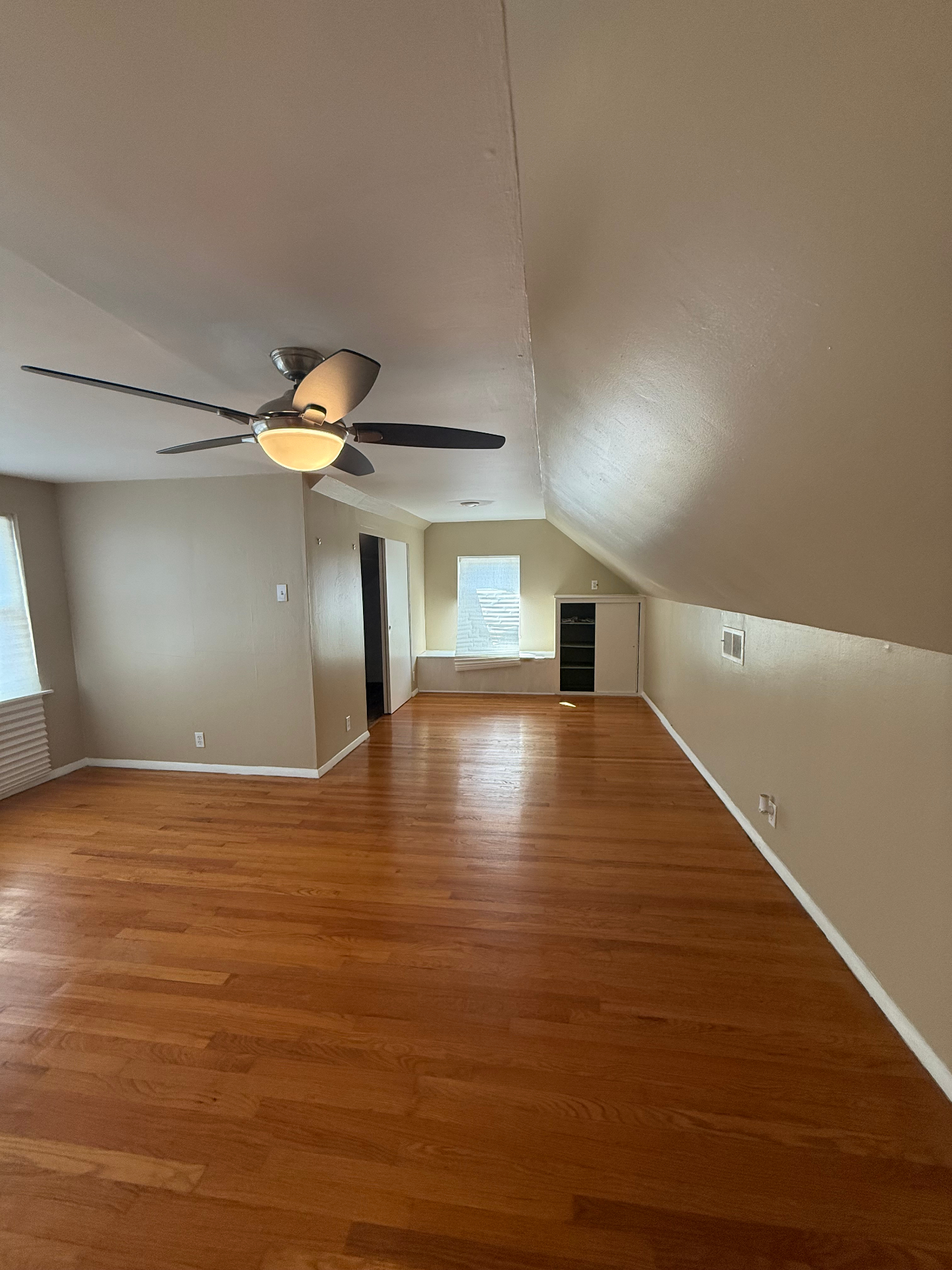 Upstairs bedroom with vaulted ceiling and built-ins