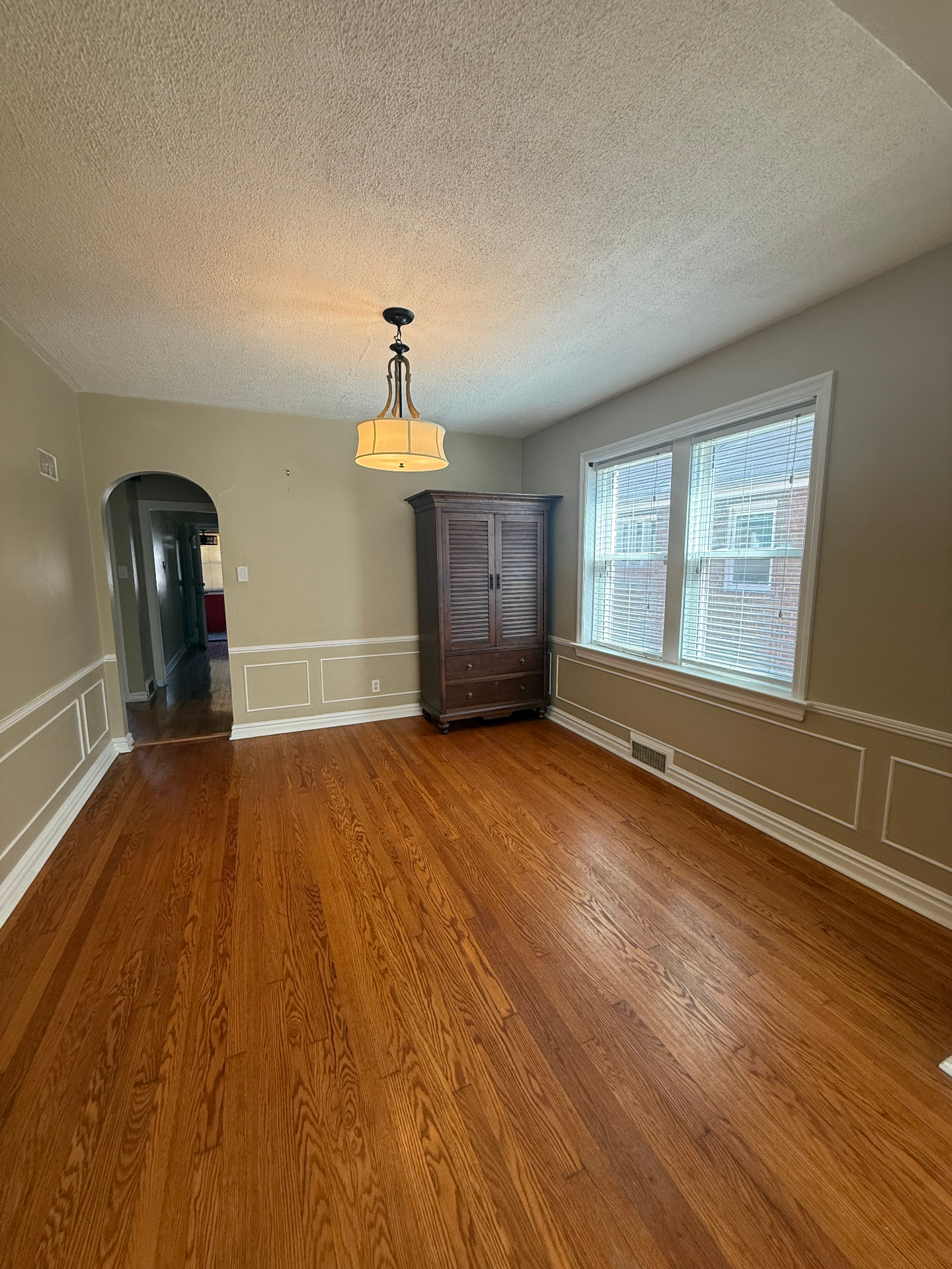 Dining room with wainscoting and large window