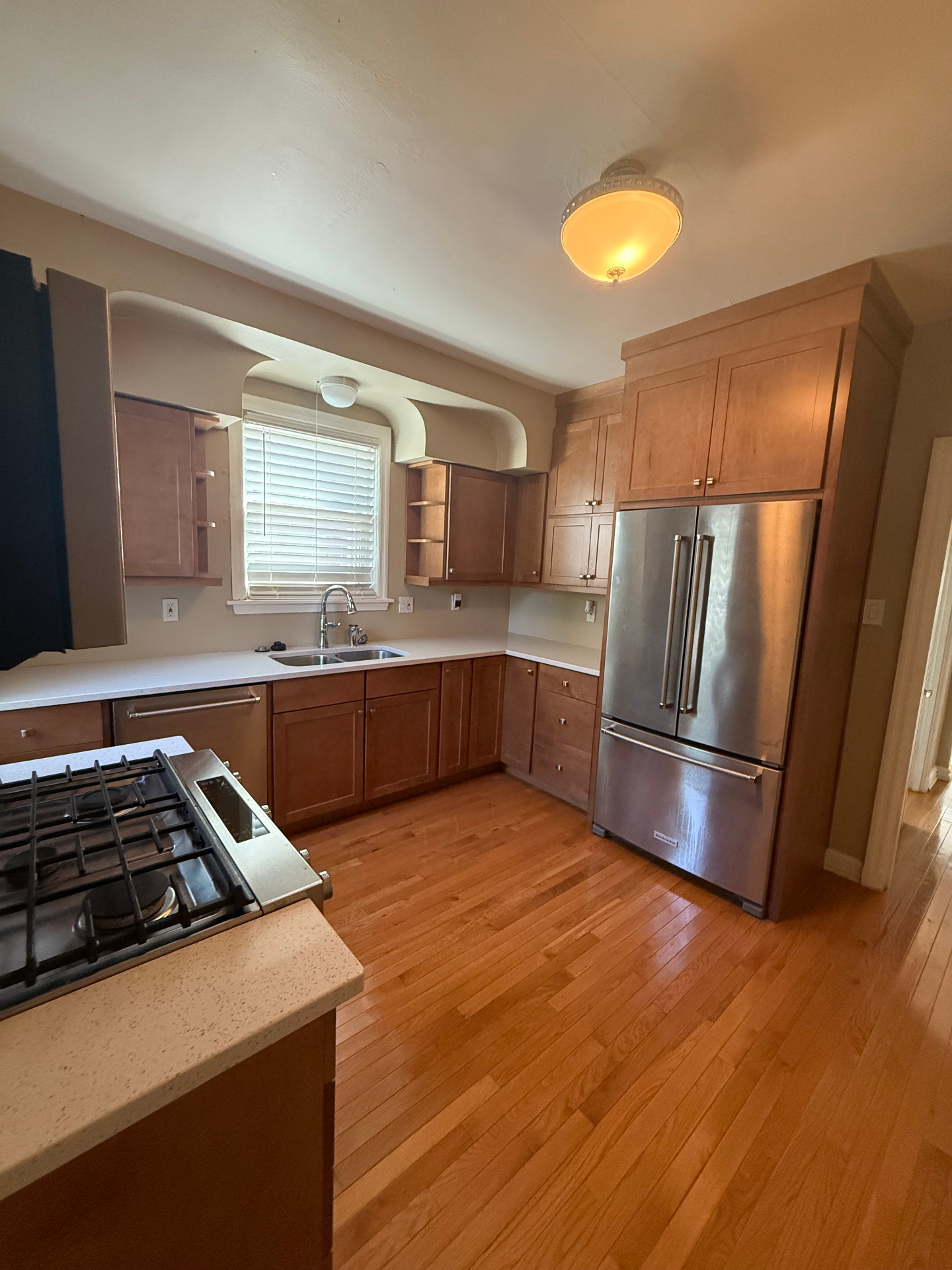Kitchen with French-door fridge and arched soffit