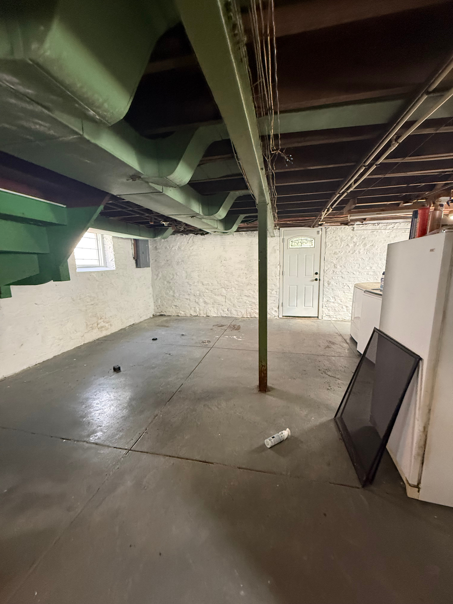 Wide basement room with side exit door