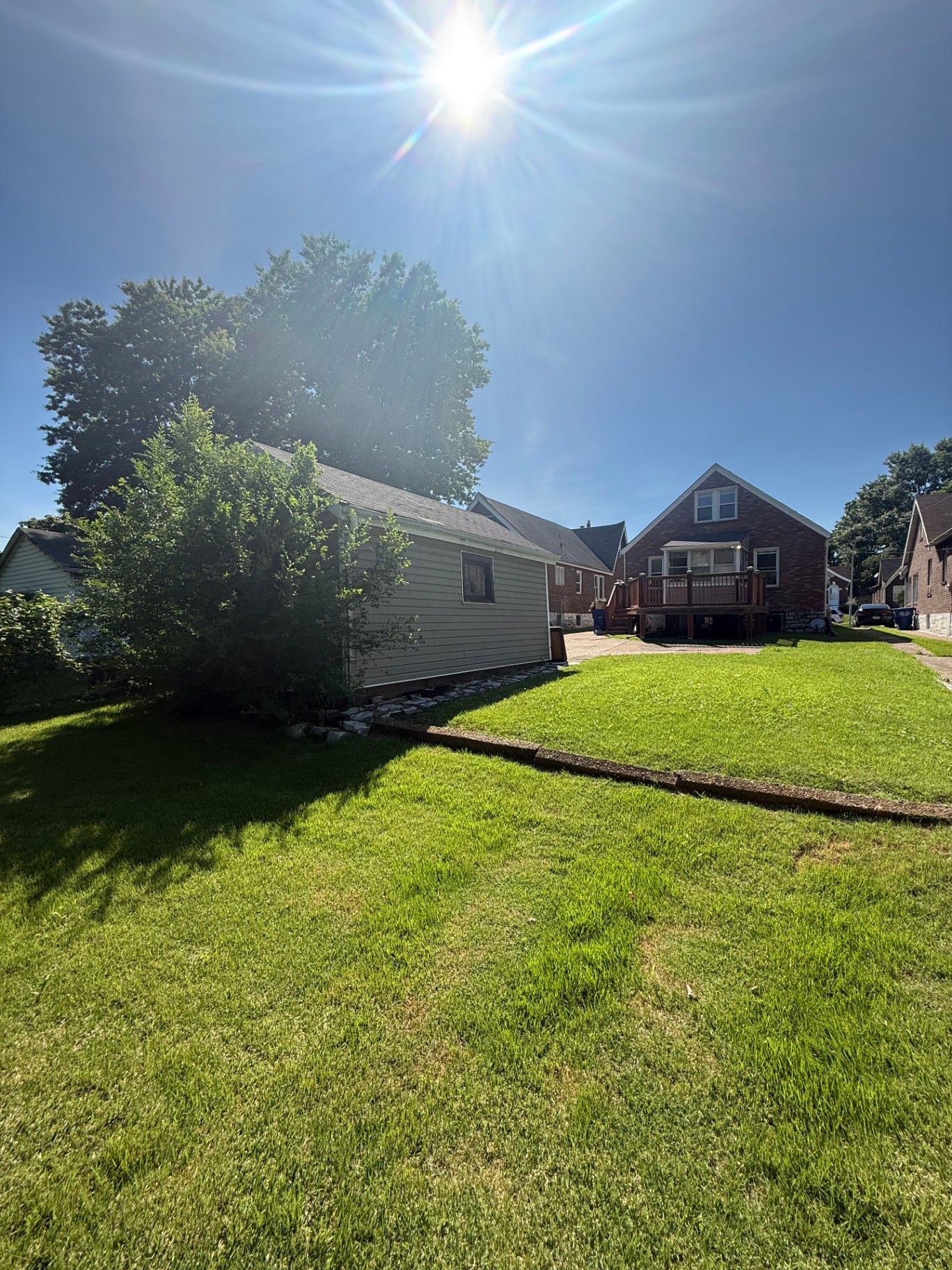Backyard with lawn, garage, and deck
