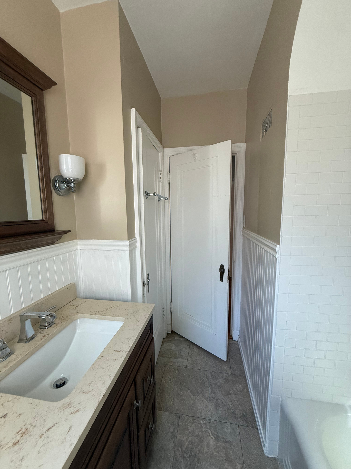 Bathroom vanity, toilet, and tile floor