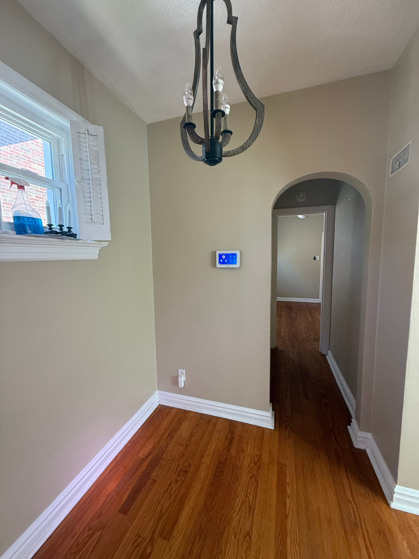 Foyer with archway and chandelier