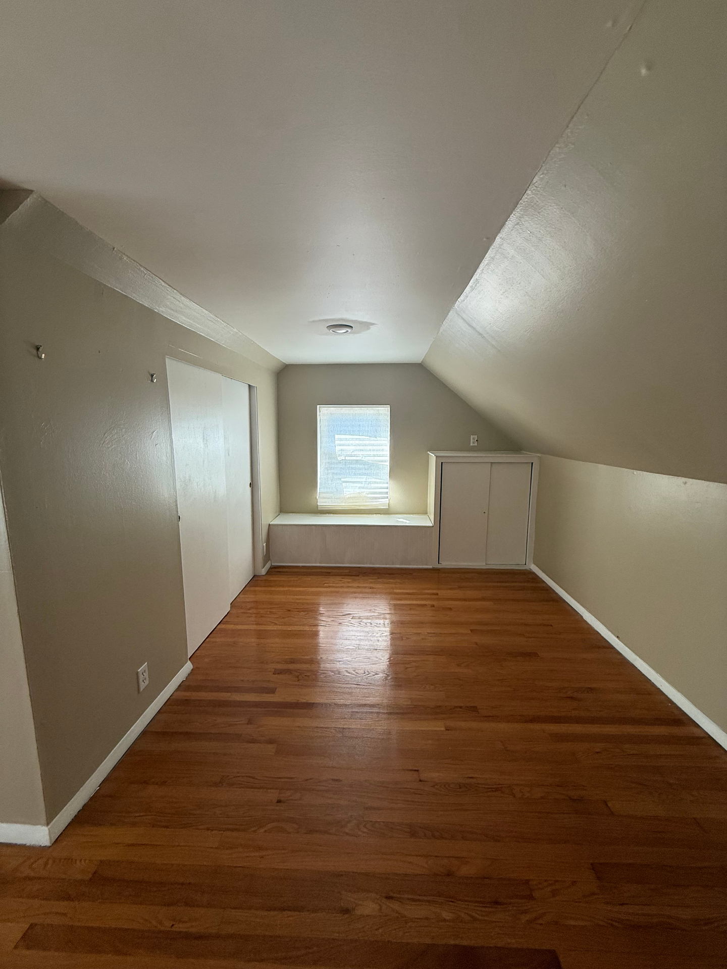 Upstairs bedroom with built-in window seat