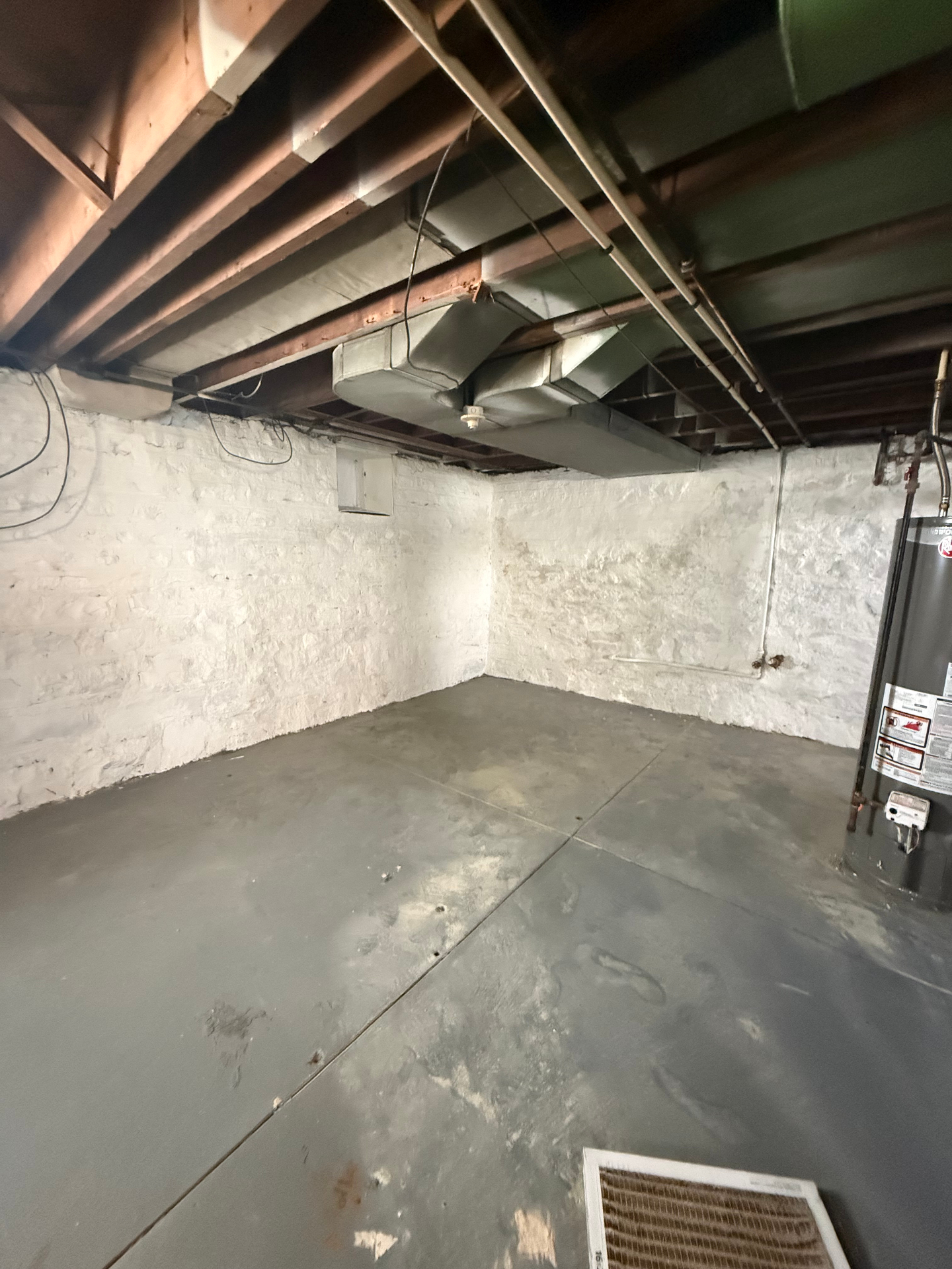 Basement storage area with exposed ductwork